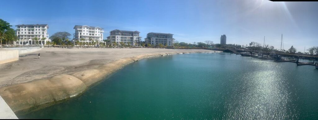 TITANTube® marina revetment panoramic — completed shoreline with resort buildings beyond