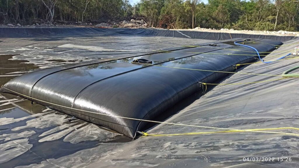TITANTube® agricultural waste dewatering — tubes in lined containment pond, Mexico