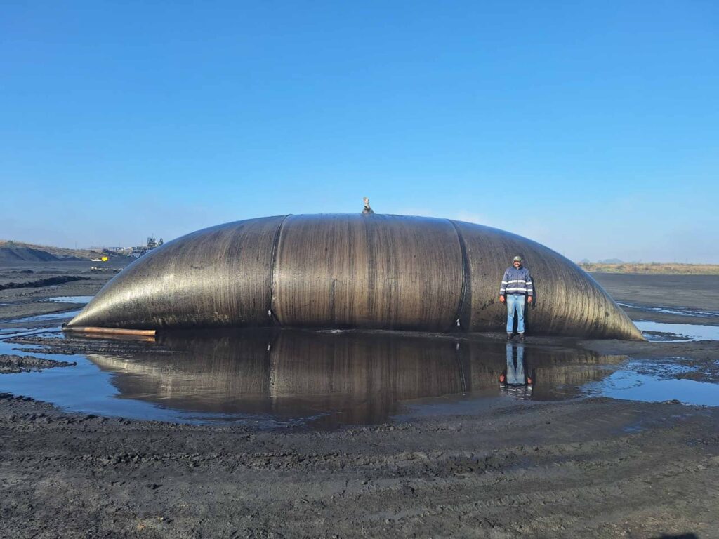 Large filled TITANTube® at chromium ore dewatering site with standing water