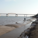 La Trocha shoreline revetment — geotextile tubes being filled along Alvarado, Veracruz, Mexico coastline