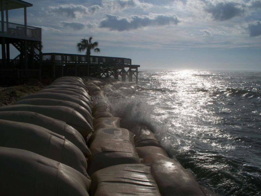 TITANBag® hurricane coastal protection — bags deflecting wave surge at beachfront property