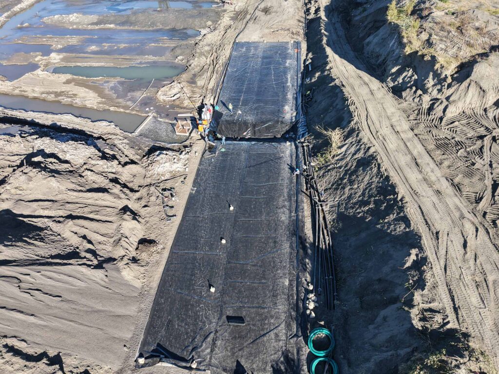 Aerial drone view — geotextile panel installation in chrome ore mining trench