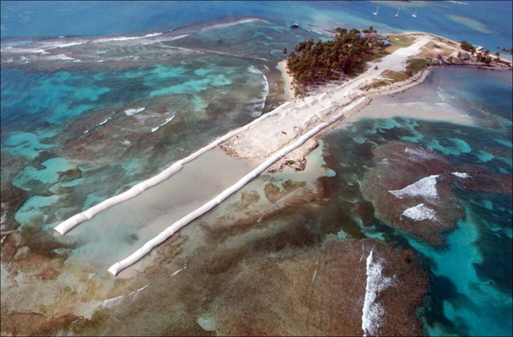 Aerial view of geotextile tube causeway construction — twin TITANTube® barriers forming a land reclamation structure in shallow coastal waters