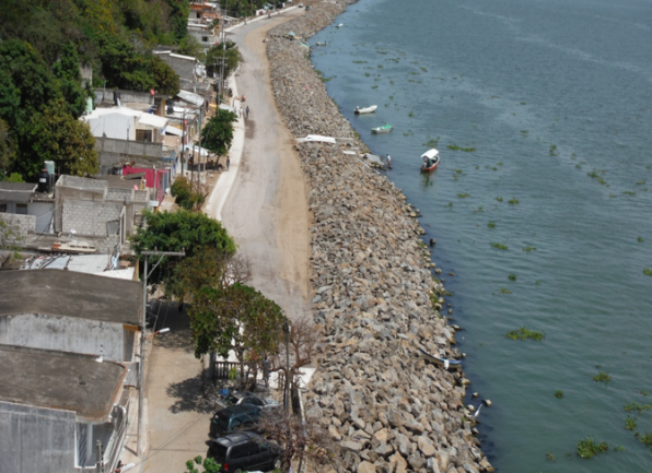 La Trocha completed revetment — aerial view of armor stone shoreline with road access restored