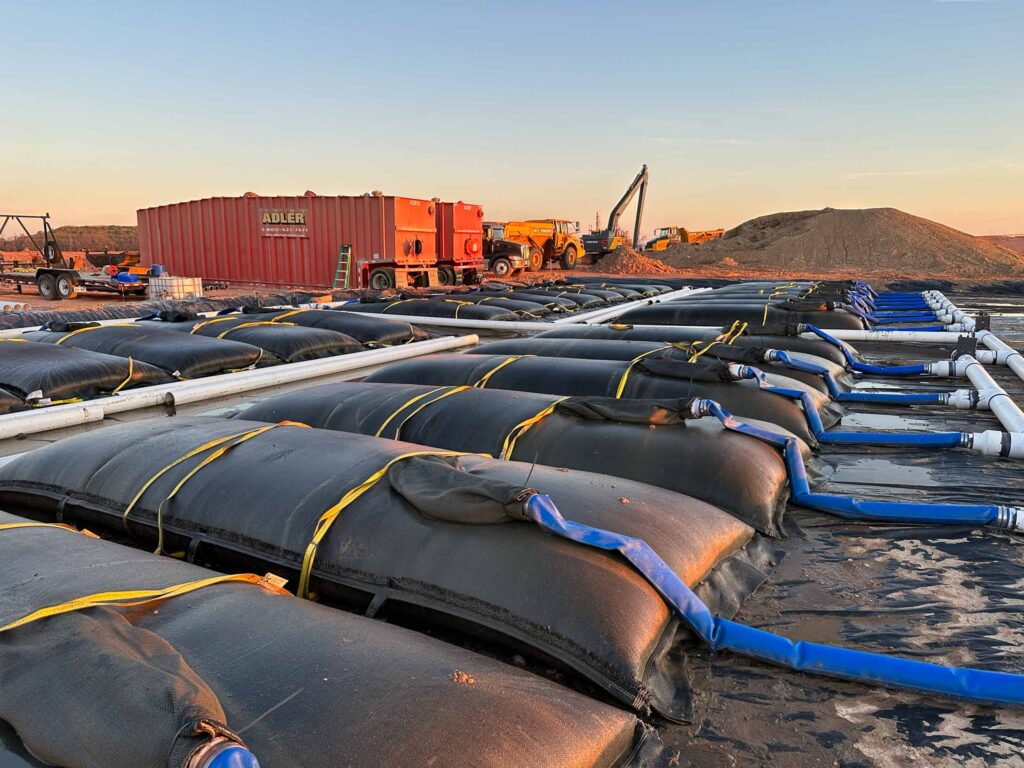 TITANTube® dewatering project site installation — full array at dusk