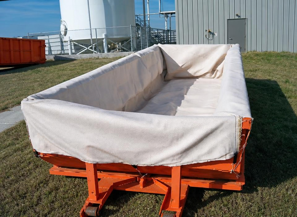 TITANLiner™ geotextile dewatering liner installed in roll-off dumpster prior to filling